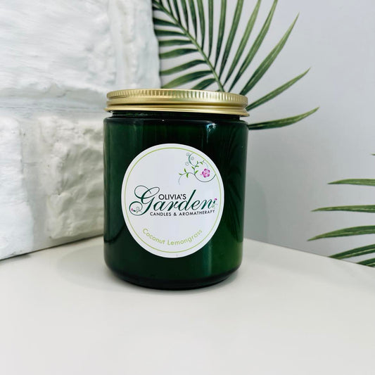 Coconut and lemongrass scented candle in a green glass jar
